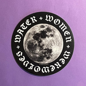 A 3-inch black and white circular sticker depicting the moon sits against a purple background. The words "water, women, werewolves" in a gothic typeface form a ring around the perimeter.